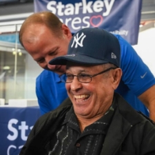 Brandon pushing a Yankee fan in a wheelchair.