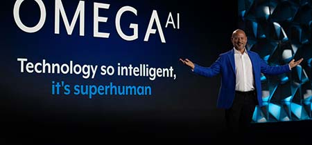 Brandon speaking on stage to a stadium of people.